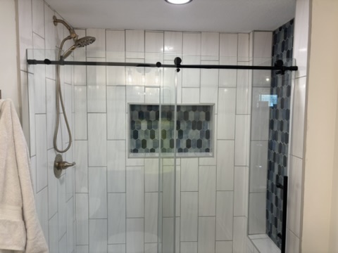 Finished tiled shower remodeled by Amped KC